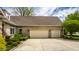 Charming brick home with a well-manicured lawn, beautiful landscaping, and attached two-car garage at 3556 Towne Dr, Carmel, IN 46032