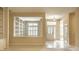 Inviting foyer with tile flooring, built-in shelving, and view to a window with shutters at 3556 Towne Dr, Carmel, IN 46032
