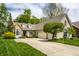 Beautifully landscaped home with a two-car garage and a long driveway at 3556 Towne Dr, Carmel, IN 46032