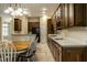 Kitchen and dining area with dark wooden cabinets and view to dining room at 3556 Towne Dr, Carmel, IN 46032