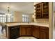 Open-concept kitchen with wooden cabinetry, sink, and views to the dining room at 3556 Towne Dr, Carmel, IN 46032