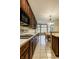 Galley kitchen with wood cabinets, tile backsplash, and adjacent breakfast nook with bright windows at 3556 Towne Dr, Carmel, IN 46032