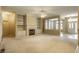 Spacious living room with fireplace, built-in shelving, and access to front entry at 3556 Towne Dr, Carmel, IN 46032