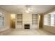 Inviting living room area featuring built in shelving, fireplace and ceiling fan at 3556 Towne Dr, Carmel, IN 46032