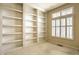 Cozy office space with built-in bookshelves and natural light from a window with shutters at 3556 Towne Dr, Carmel, IN 46032