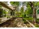 View of the patio adjacent to a sunroom overlooking a green yard at 3556 Towne Dr, Carmel, IN 46032