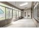 Cozy sunroom featuring brick accents, skylight, ceiling fan, and windows offering views of backyard at 3556 Towne Dr, Carmel, IN 46032