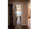 Hallway view of bathroom with glass shower door and wood floors at 3646 Creston Dr, Indianapolis, IN 46222
