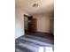 Bedroom with dark wood-look floors and standing lamp at 3646 Creston Dr, Indianapolis, IN 46222