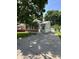 Charming single-story home with brick accents and green siding, complemented by a long concrete driveway at 3646 Creston Dr, Indianapolis, IN 46222