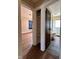 Hallway view into bedroom and bathroom, featuring updated flooring and natural light at 3646 Creston Dr, Indianapolis, IN 46222