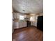 Well-lit kitchen features updated appliances, hardwood floors, and abundant storage at 3646 Creston Dr, Indianapolis, IN 46222