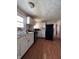 Functional kitchen with white cabinets, black appliances, and wood-look flooring at 3646 Creston Dr, Indianapolis, IN 46222
