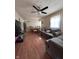 Cozy living room with hardwood floors, a ceiling fan, a comfortable sofa and a view into dining area at 3646 Creston Dr, Indianapolis, IN 46222