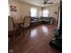 Open-concept living and dining area with neutral walls, window, and wood-look floors at 3646 Creston Dr, Indianapolis, IN 46222