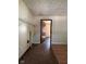 Room with worn flooring, white shelving, and doorway to another room at 3646 Creston Dr, Indianapolis, IN 46222