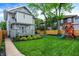 Home exterior with an expansive green lawn, play-set, deck, and patio, perfect for outdoor activities and entertaining at 3918 N Park Ave, Indianapolis, IN 46205