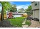 A spacious backyard featuring a play-set, green lawn and detached garage offering ample space and storage at 3918 N Park Ave, Indianapolis, IN 46205