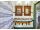 Bright bathroom featuring a dual sink vanity with granite top, and a shower with a patterned curtain at 3918 N Park Ave, Indianapolis, IN 46205