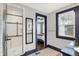 Stylish bathroom showcases a tiled shower and floors, complemented by dark trim and a bedroom view at 3918 N Park Ave, Indianapolis, IN 46205