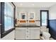 Bathroom with dual sinks, white cabinetry, a tiled backsplash, and lots of natural light at 3918 N Park Ave, Indianapolis, IN 46205