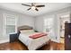 Bedroom with two windows, gray walls, and hardwood floors at 3918 N Park Ave, Indianapolis, IN 46205