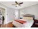 A cozy bedroom boasts a comfortable bed, side tables, and a ceiling fan for added comfort and style at 3918 N Park Ave, Indianapolis, IN 46205