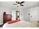 This bedroom features gray walls, a ceiling fan, a dresser, and easy access to other parts of the home at 3918 N Park Ave, Indianapolis, IN 46205