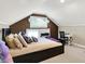 Attic bedroom featuring cozy bed, desk with chair, natural light, and unique architectural elements at 3918 N Park Ave, Indianapolis, IN 46205