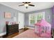 ' bedroom with hardwood floors, a ceiling fan, and a pink play tent for hours of fun at 3918 N Park Ave, Indianapolis, IN 46205