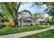 Charming home showcasing well-manicured lawn, mature trees, and a classic two-story design at 3918 N Park Ave, Indianapolis, IN 46205