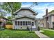 Charming two-story home featuring a cozy screened-in porch and well-maintained landscaping at 3918 N Park Ave, Indianapolis, IN 46205