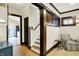 Hallway featuring wood trim, stairs, and an open view of the kitchen at 3918 N Park Ave, Indianapolis, IN 46205