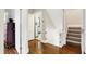 Hallway featuring hardwood floors and doors to the bathroom and stairwell at 3918 N Park Ave, Indianapolis, IN 46205