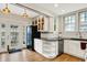 Spacious kitchen featuring white cabinets, a black refrigerator, and backyard access at 3918 N Park Ave, Indianapolis, IN 46205