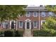 Charming brick townhome with classic blue shutters and meticulously maintained landscaping at 4024 Heyward Pl, Indianapolis, IN 46250