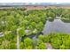 Aerial shot showcasing a serene lake surrounded by dense, green forests at 4154 W Briarwood Lake S Dr, Monrovia, IN 46157