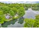Serene aerial view of a home surrounded by lush trees and nestled along a calm lake at 4154 W Briarwood Lake S Dr, Monrovia, IN 46157