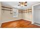 Bedroom featuring a ceiling fan, hardwood floors, window, shelves, and a closet space at 4154 W Briarwood Lake S Dr, Monrovia, IN 46157