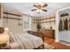 Bedroom with a hardwood floor, a ceiling fan, shelves, a bed, a rug, a dresser, and a closet at 4154 W Briarwood Lake S Dr, Monrovia, IN 46157