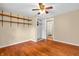 Bedroom featuring hardwood floors, shelves, ceiling fan, closet, and a view of the bathroom at 4154 W Briarwood Lake S Dr, Monrovia, IN 46157