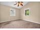 This bedroom boasts natural lighting through windows and neutral carpet at 4154 W Briarwood Lake S Dr, Monrovia, IN 46157