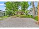 Charming single-story home with a gravel driveway and covered front porch nestled among mature trees at 4154 W Briarwood Lake S Dr, Monrovia, IN 46157
