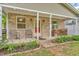 Inviting brick porch featuring outdoor seating, decorative plants, and wood storage at 4154 W Briarwood Lake S Dr, Monrovia, IN 46157