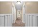 Hallway with neutral-colored walls, white trim, and carpeted floors; doors on either side at 4154 W Briarwood Lake S Dr, Monrovia, IN 46157