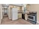 Kitchen area with white appliances, neutral cabinets, laminate counters, and carpeted flooring at 4154 W Briarwood Lake S Dr, Monrovia, IN 46157