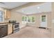Open kitchen area with stainless appliances, light wood cabinets, and windows overlooking the backyard at 4154 W Briarwood Lake S Dr, Monrovia, IN 46157