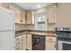 Kitchen with white appliances, neutral cabinets, laminate counters, and stainless steel oven at 4154 W Briarwood Lake S Dr, Monrovia, IN 46157