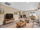 Staged living room offers comfortable seating, a coffee table, and a view into the eat-in kitchen at 4154 W Briarwood Lake S Dr, Monrovia, IN 46157