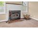 Living room with a fireplace, windows, brick hearth and wood storage area at 4154 W Briarwood Lake S Dr, Monrovia, IN 46157